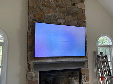 Above fireplace TV mounting with wire concealment